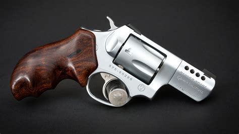 A shooter firing a.38 Special revolver at a target