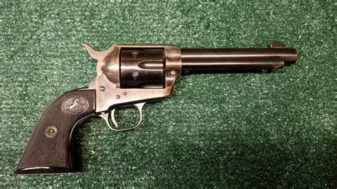 A group of collectors admiring a vintage 45 Long Colt pistol