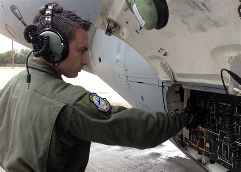 Air Force Crew Chief inspecting an aircraft engine