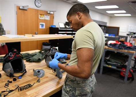 Aircrew flight equipment specialist inspecting a flight helmet