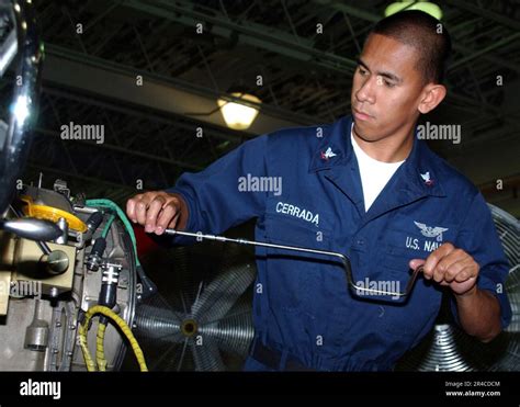 Aviation Machinist Mate inspecting an engine