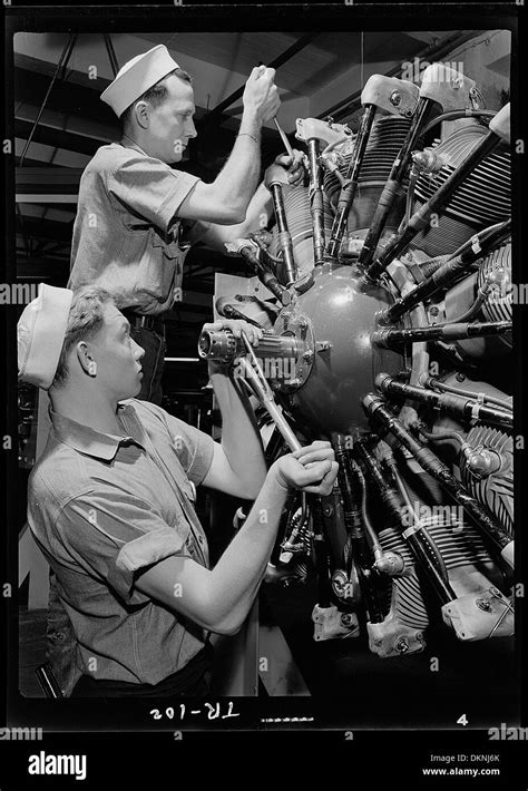 Aviation Machinist Mate working on an aircraft engine