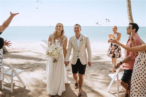 Couple on a beach, looking at a map