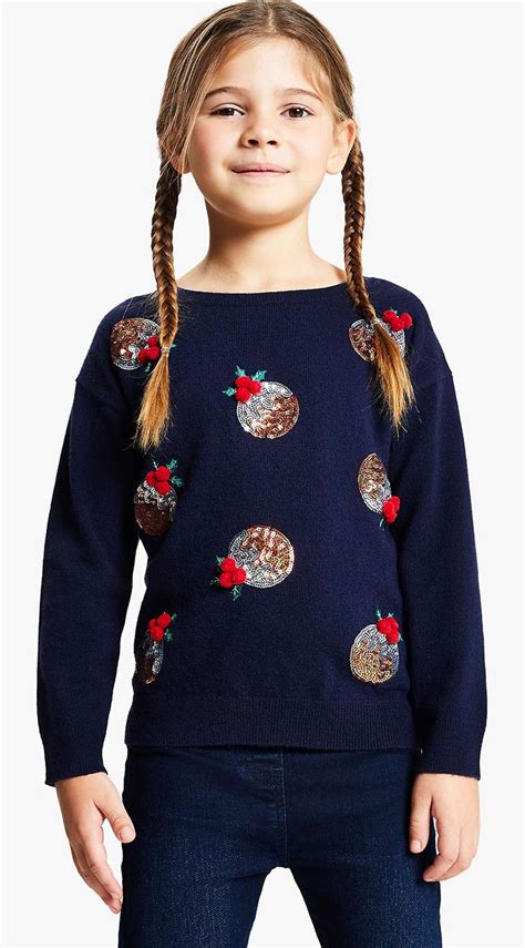 A person adding an applique to a Christmas jumper