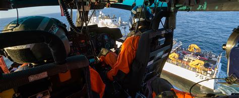 A Coast Guard officer discusses career options with a group of students