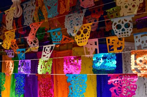 A colorful papel picado hanging in a street