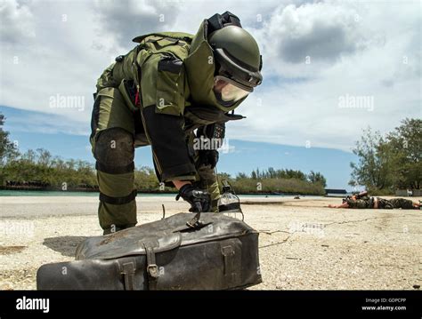 EOD technician examining explosive device