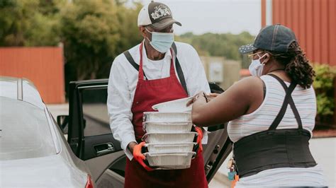 A food pantry volunteer assisting a client