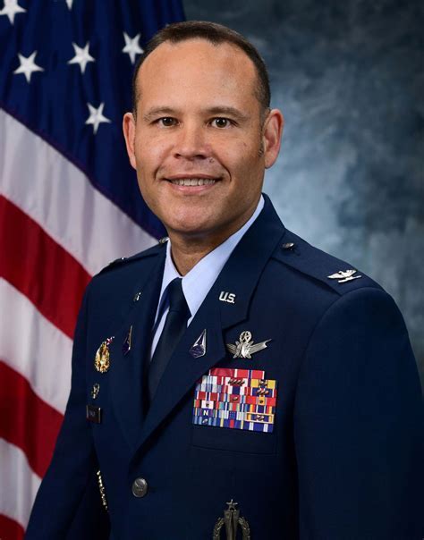 A general in uniform, saluting the flag