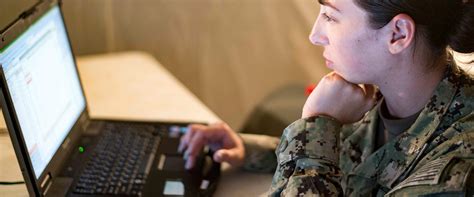 Information Systems Technician repairing a computer system