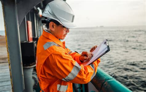 A Coast Guard marine safety inspector examines a commercial vessel's safety equipment