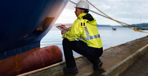 A Coast Guard inspector examines a commercial vessel's safety equipment