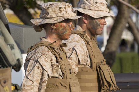 A Marine standing at attention, wearing the service uniform