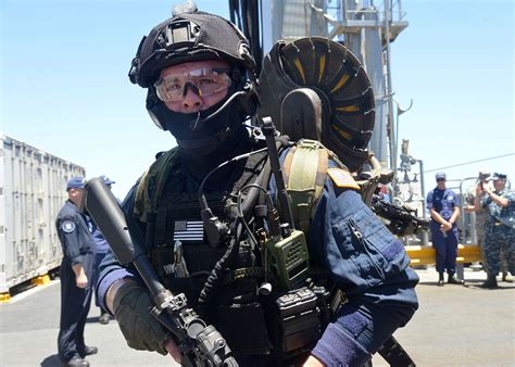 A Coast Guard maritime law enforcement officer boards a suspect vessel