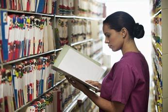 Medical Health Records Technician Organizing Files