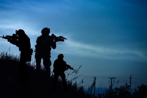 Military personnel working on aircraft engines