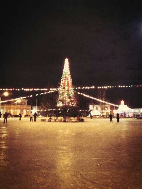 Ice skaters gliding across the ice at a Montana rink at Christmas