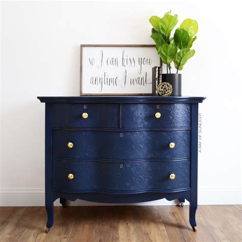 Navy blue dresser and lighting