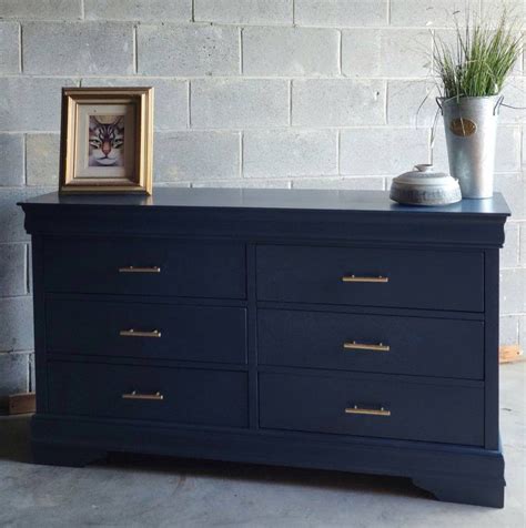 Navy blue dresser and wall decor