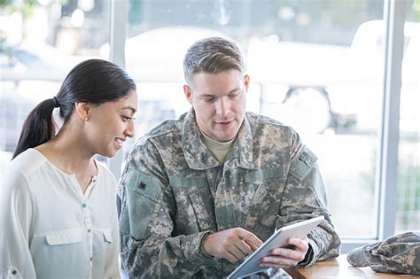 A Navy recruiter explaining career options to a group of applicants