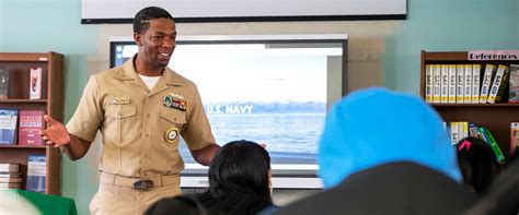 Navy recruiter meeting with a group of potential recruits