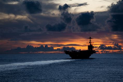 A Navy personnel in reflective pose