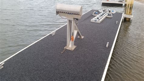 Pontoon-based repairs on an aircraft carrier, showing the use of floating pontoons.