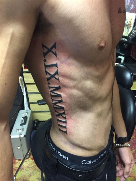 Roman Numeral Rib Tattoo Designs