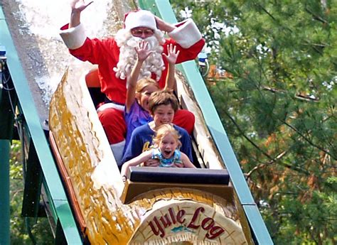 A festive holiday display at a theme park with Santa's sleigh