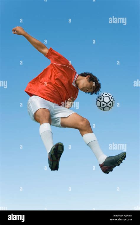 A Soccer Player Jumping for the Ball