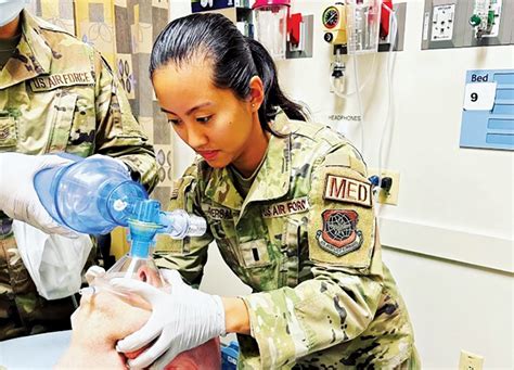 US Air Force Nurse working with patients