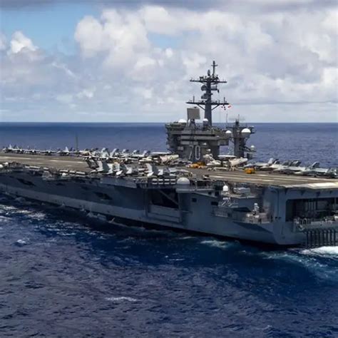 The USS Nimitz (CVN-68) undergoing a major modernization program, highlighting its upgraded propulsion system