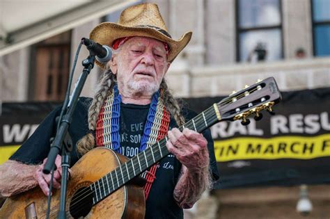 Willie Nelson performing on stage