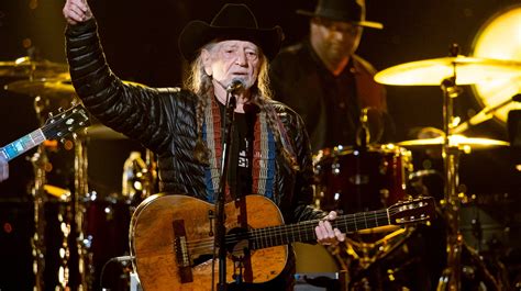 Willie Nelson performing on stage