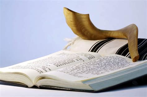 Person sitting in a synagogue, reflecting on Yom Kippur