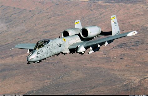 A-10 Thunderbolt II flying low over a desert landscape