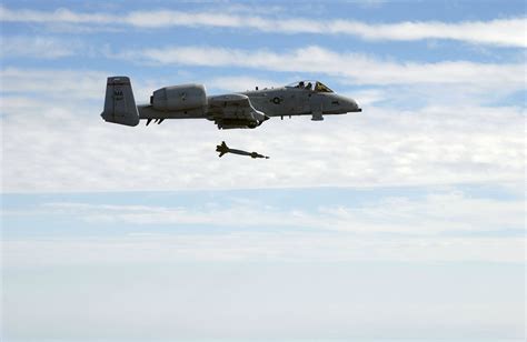 A-10 Warthog releasing a laser-guided bomb at night