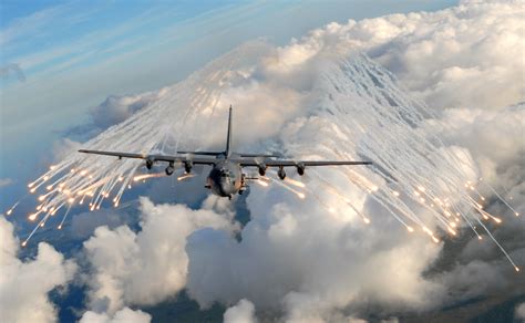 AC-130 Gunship flying low over a desert landscape