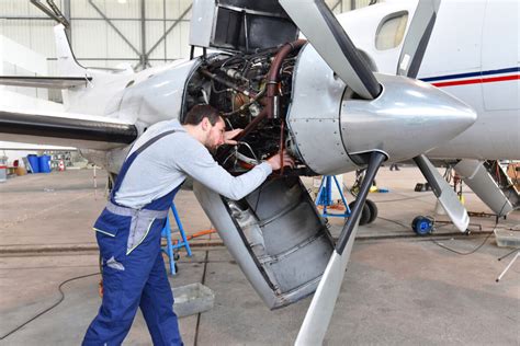 Aerospace Engineers maintaining an aircraft engine