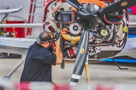 Aircraft mechanic inspecting an engine