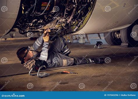 Aircraft mechanic inspecting an aircraft