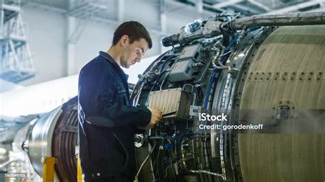 Aircraft mechanic inspecting an engine