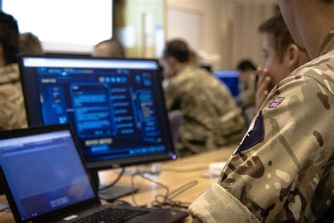 Army Cyber Security Specialist working on a computer