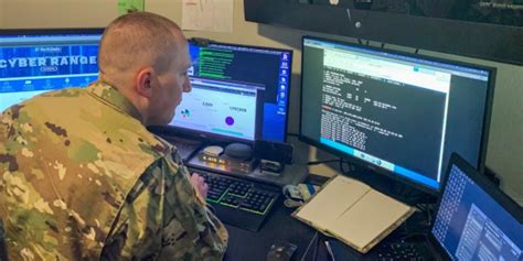 Army Information Technology Specialist working on a computer