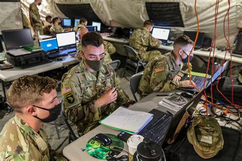 Army Intelligence Analyst working on a computer