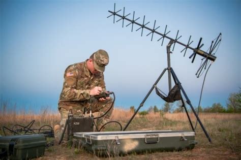 Army Signal Support Systems Specialist working on a communication system