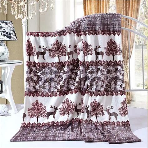 Newborn baby on a reindeer-print blanket