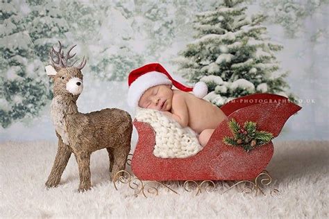 Newborn baby in a Santa sleigh