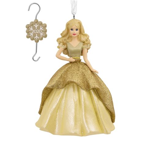 Barbie decorating a Christmas tree with ornaments