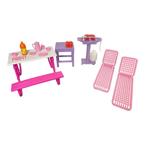 A miniature picnic setup with Barbie dolls